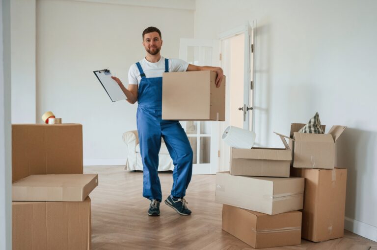 Room full of boxes. Moving service employee
